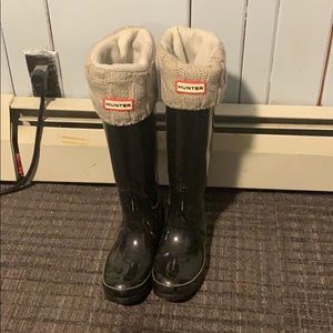 Tall hunter boots with grey socks